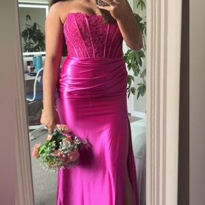 Magenta strapless prom dress.
Has lace and gems on the corset and only worn once